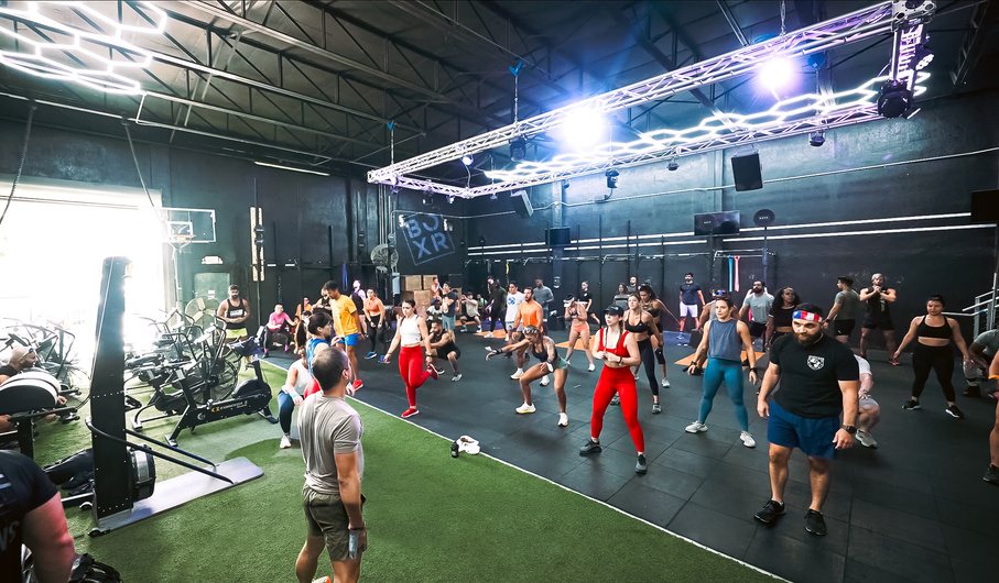 A packed CrossFit class on the green turf at BOXR