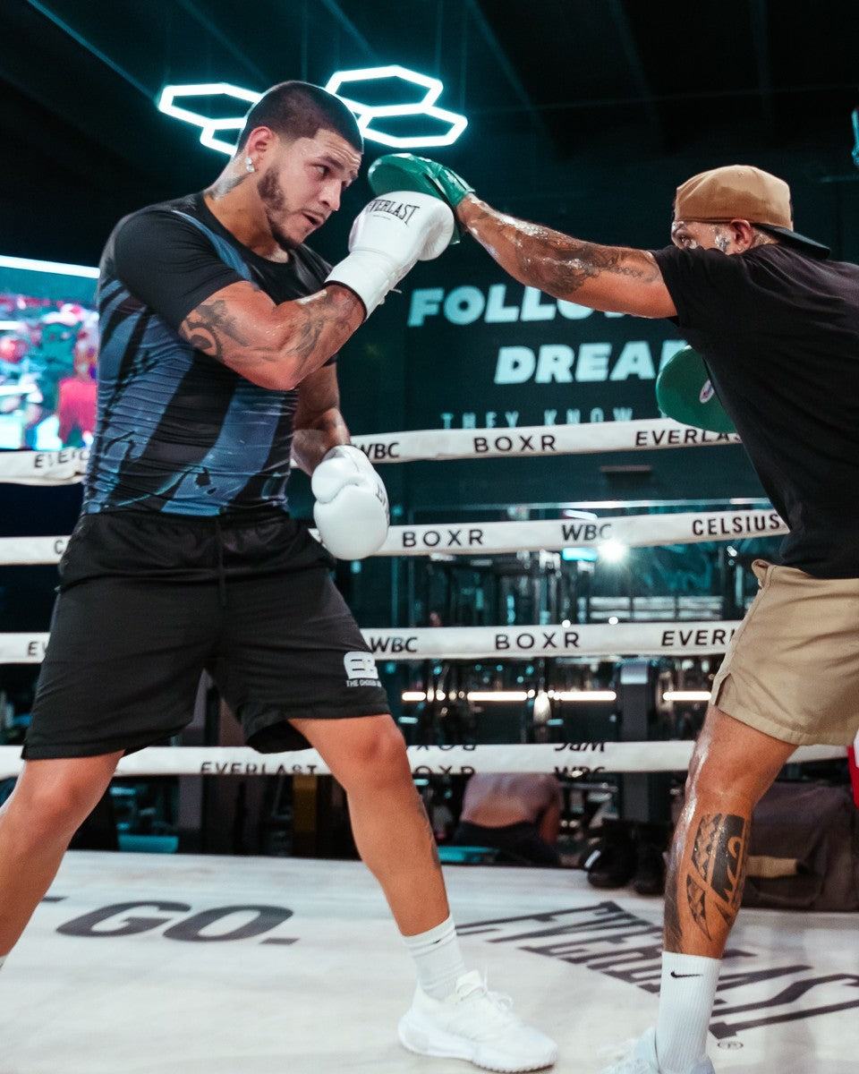 Edgar Berlanga on the mitts in the BOXR ring under the teal hex lights, the Follow Your Dreams wall behind.